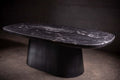 Table de salle à manger - Une étude en contraste — le plateau en quartzite cuiré offre une profondeur tactile qui change avec la lumière, ancré par un mat noir...